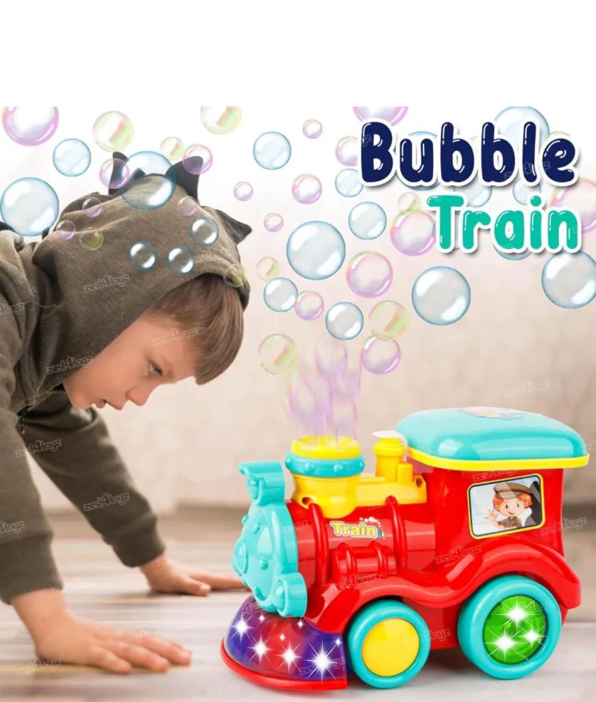 A child wearing a hoodie looks intently at a colorful bubble-blowing train toy on the floor.