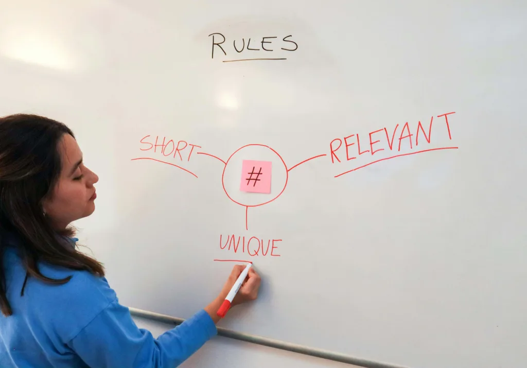 A mentor writing the importance of rules on white board with marker